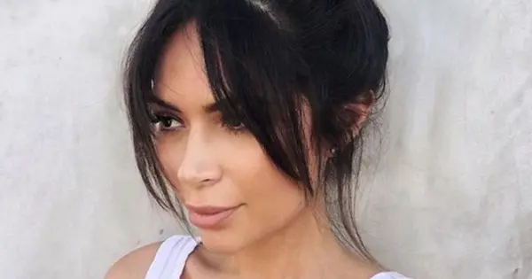 Kim Kardashian's hair returns to its natural hue, styled in a chic low-maintenance asymmetric bob for a fresh look.