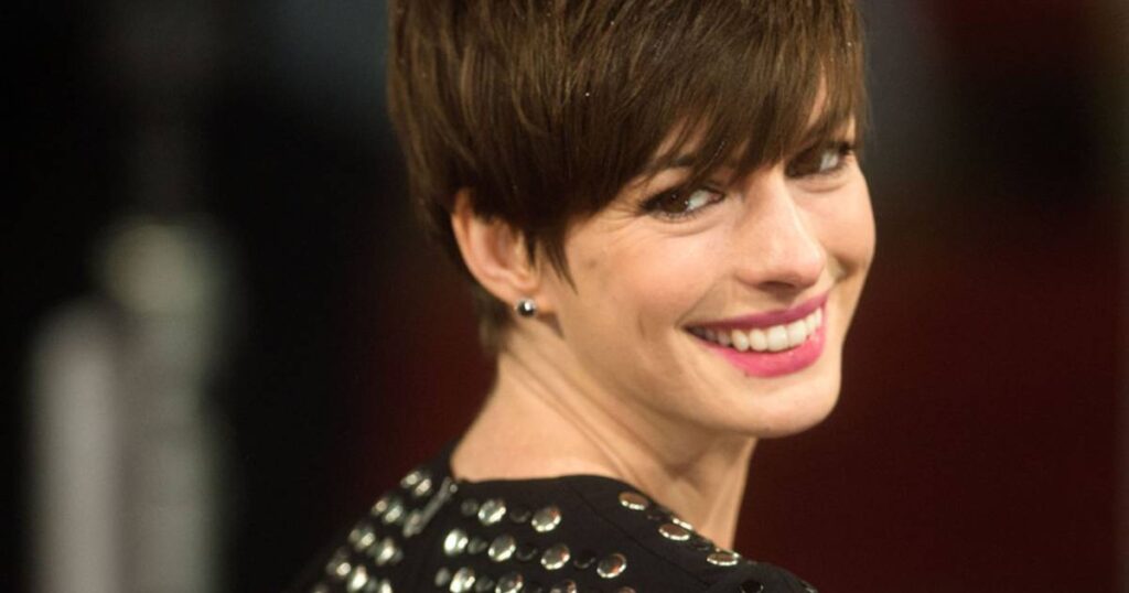 Anne Hathaway showcasing a Textured Pixie With Undercut Bangs at the BAFTAs, exuding elegance and style on the red carpet.