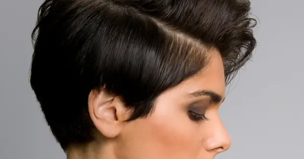 A woman with a short black hairstyle, featuring straight strands, exuding a casual and relaxed appearance.
